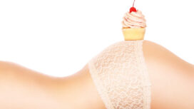 26100541 - a picture of a fresh cupcak placed on a sensual female butt