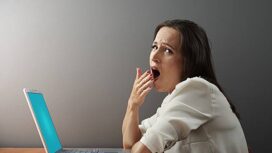 boring woman sitting with laptop and yawning