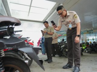 Kepala Bapenda Sumsel Ahmad Rizwan saat mengecek pajak kendaraan yang sedang parkir. Foto : Bapenda Sumsel